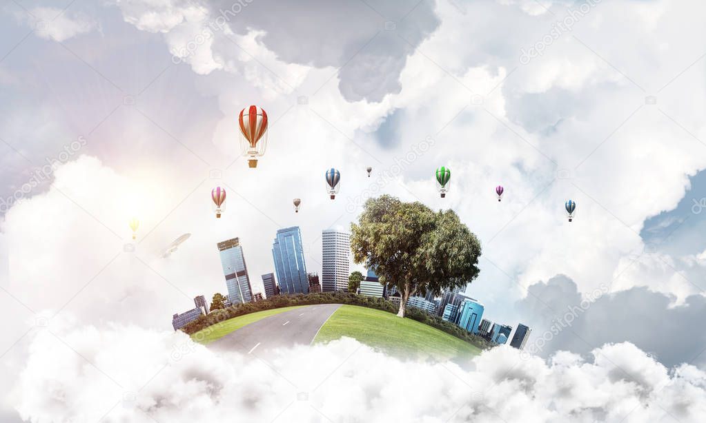 Green flying island with urban view of towers and skyscrapers. Flying aerostates and blue cloudy skyscape on background. 