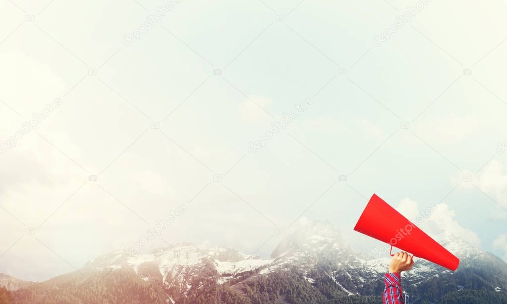 Close of woman making announcement in paper trumpet