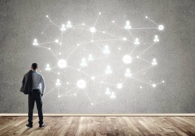 Arkadan görünüşü çizilmiş sosyal bağlantı kavramı ile duvara bakarak işadamı
