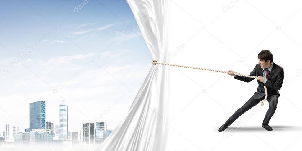 Businessman pulling white blank fabric