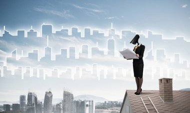 Evin çatısında baş durmak yerine kamerayla zum yapan yüzsüz iş kadını.