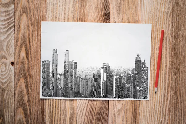 近代的な市内中心部の鉛筆画 木製の表面に高い高層ビルのスケッチと都市現代都市のパノラマ 質感の天然木の背景に紙のシート 建築設計事務所のコンセプト — ストック写真