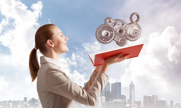 Woman Holding Open Notebook Flying Abstract Mechanism Cogwheels Construction Manufacturing — Stock Photo, Image