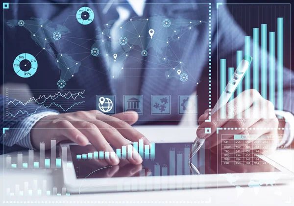 Businessman analyzing financial data at tablet computer. Interactive financial diagrams, trading indicators and exchange indexes. Innovation technology and global business corporation concept