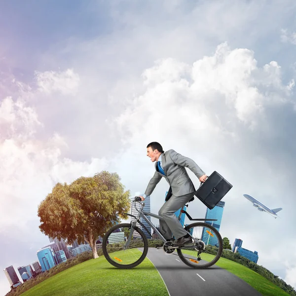 Young man riding bicycle on highway — Stock Photo, Image