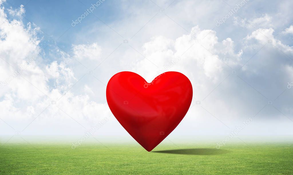Big red heart on green field. Love and tenderness, valentines holiday and fall in love concept. Beautiful landscape with green grass and cloudy blue sky. Mixed media with 3D rendering object.