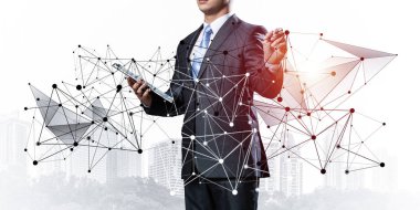 Businessman with documents pointing on abstract network composition. Entrepreneur in business suit and tie without face. Internet marketing and business development. Mixed media with virtual network