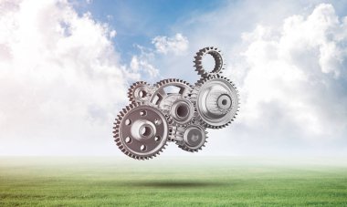Yeşil çayır üzerinde dişli tekerlekler ile soyut mekanizma