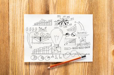 Ticari doodle grubu ile çizilmiş Iş infographics kalem el. Ahşap masa üzerinde kağıt ve kalem ile işyeri üst görünümü. Finansal istatistikler ve analiz. Ampul ve grafikler