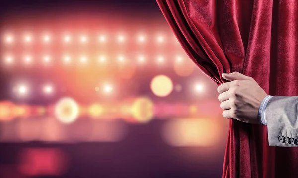 Bokeh lights behind drapery curtain and hand opening it — Stock Photo, Image