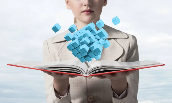 年轻女子拿着打开的书与飞行的3D蓝色立方体 具有虚拟现实元素的高科技概念 特写打开书在女性手中 穿着西装的优雅女士在模糊的光线背景 — 图库照片