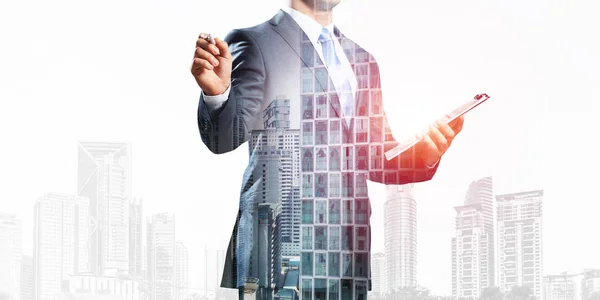 Businessman pointing on empty space on background modern cityscape. Standing entrepreneur in business suit and tie without face. Double exposure template. Blank screen ready for business message