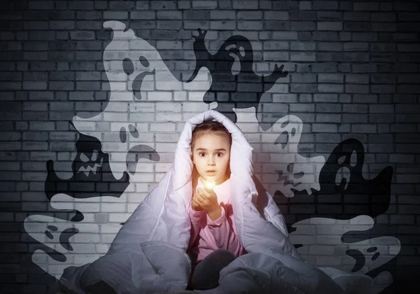 惊讶的女孩用手电筒躲在毯子下 惊讶的孩子坐在他的床上在家里 害怕黑暗 穿着睡衣的小孩晚上怕鬼 噩梦幻想和想象 — 图库照片