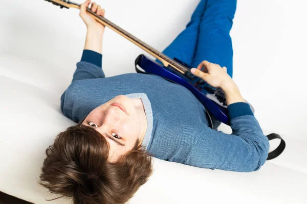 Jovem Feliz Deitado Sofá Com Guitarra Guitarrista Sorridente Relaxando Sofá — Fotografia de Stock