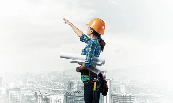 Female Engineer Hardhat Standing Technical Blueprints Pointing Upwards Side View — Stock Photo, Image