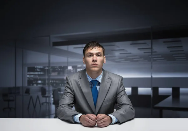Young man folded hands and having serious face — Stock Photo, Image