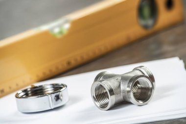 Sıhhi tesisat boru hattı konektörü masaya yatıyor. Ev su sistemi planlama ve montaj hizmeti. Hidrolik sistem için çelik su bağlantı parçaları ve bağlantıları. Banyo tamiri veya inşaatı için ekipmanlar.