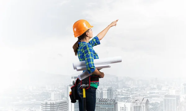 Female Engineer Hardhat Standing Technical Blueprints Pointing Upwards Side View — Stock Photo, Image