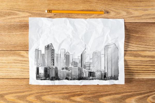 大きな街のスカイライン鉛筆を描く 木製の表面に高い高層ビルのスケッチと近代的なダウンタウンの風景 質感のある天然木の背景に紙や鉛筆 不動産仲介業の概念 — ストック写真