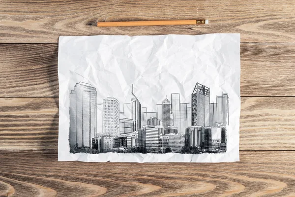 大きな街のスカイライン鉛筆を描く 木製の表面に高い高層ビルのスケッチと近代的なダウンタウンの風景 質感のある天然木の背景に紙や鉛筆 不動産仲介業の概念 — ストック写真