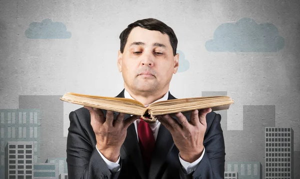 Serious businessman holding open book. Adult man in business suit standing on city illustration background. Lawyer reading big legal regulation book. Professional business accounting and consulting
