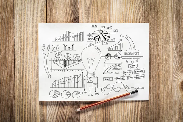 Business infographics pencil hand drawn with group of commercial doodles. Top view of workplace with paper and pencil lying on wooden desk. Financial statistics and analytics. Light bulb and charts