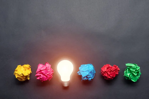 Lightbulb Crumpled Colorful Paper Balls Black Background Successful Solution Problem — Stock Photo, Image