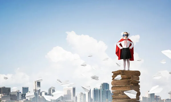 Young Girl Superhero Costume Standing Pile Old Books Mixed Media — Stock Photo, Image