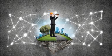 Beton arka planda uçan yeşil adada mühendis.