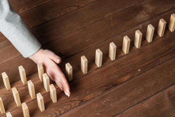 Businesswoman Protecting Dominoes Falling Wooden Desk Business Assistance Leadership Crisis — Stock Photo, Image