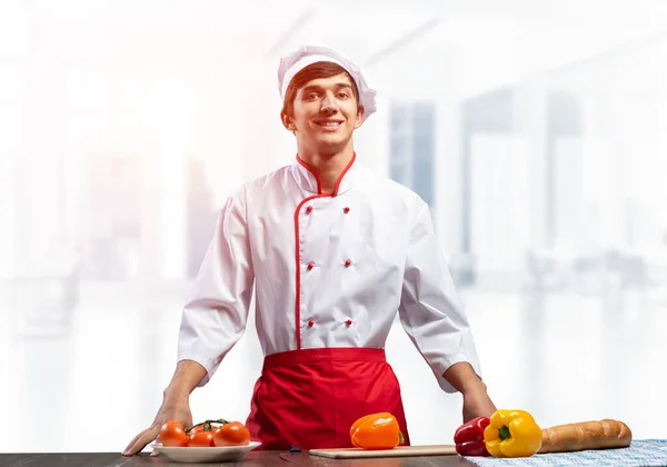 Young Smiling Chef Standing Cooking Table Fresh Vegetables Pleased Chef — Stock Photo, Image