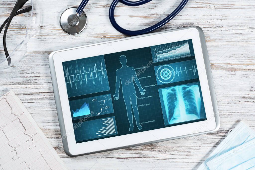 Medical diagnostics in modern pulmonology. Tablet computer with medical application interface on screen. Top view stethoscope and cardiogram on wooden desk. Digital tuberculosis screening test