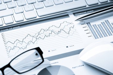 Klavye fareli iş yeri ve grafik ve diyagramlı kağıtlar