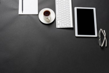 Tablet bilgisayarlı modern iş yeri manzarası. Düz siyah yüzey, fotokopi alanı ve bir fincan kahveyle yatıyordu. Profesyonel danışmanlık, denetim ve muhasebe. Dijital teknoloji ve mobil yaşam tarzı.