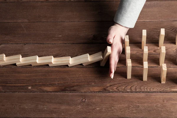 Businesswoman Protecting Dominoes Falling Wooden Desk Business Assistance Leadership Crisis — Stock Photo, Image