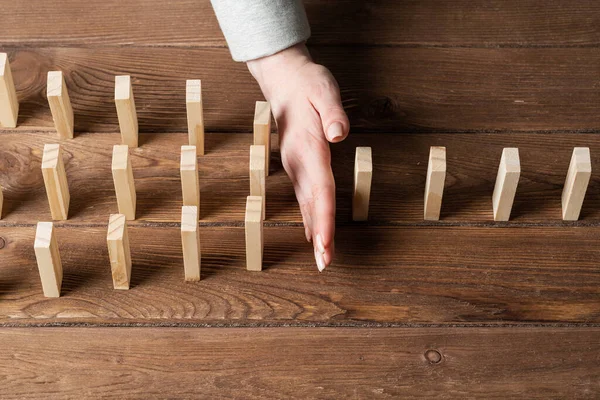 Businesswoman Protecting Dominoes Falling Wooden Desk Business Assistance Leadership Crisis — Stock Photo, Image