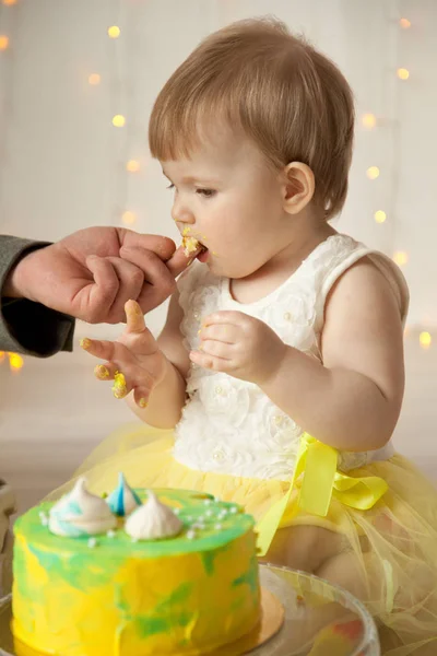 little baby birthday one year girl crushing her yellow cake