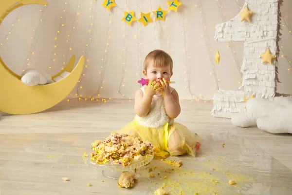 Pequeño bebé cumpleaños un año chica aplastando su amarillo pastel — Foto de Stock