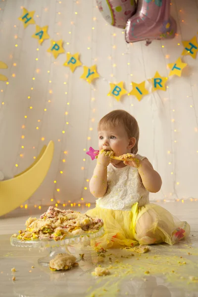 little baby birthday one year girl crushing her yellow cake