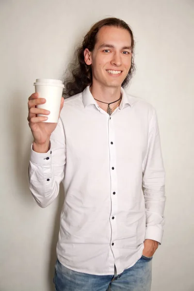 Schöner freundlicher, fröhlich lächelnder Mann mit einer Tasse Kaffee-Tee auf weißem Hintergrund allein — Stockfoto