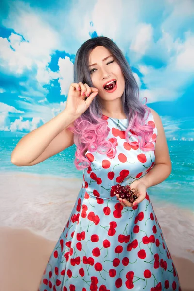 Χαρούμενη νέοι pin up κορίτσι τρώει το γλυκό κεράσι στέκεται μόνη της — Φωτογραφία Αρχείου
