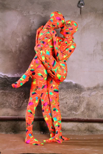 Two orange zentai fetish girl playing — Stock Photo, Image