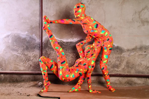 Two orange zentai fetish girl playing — Stock Photo, Image