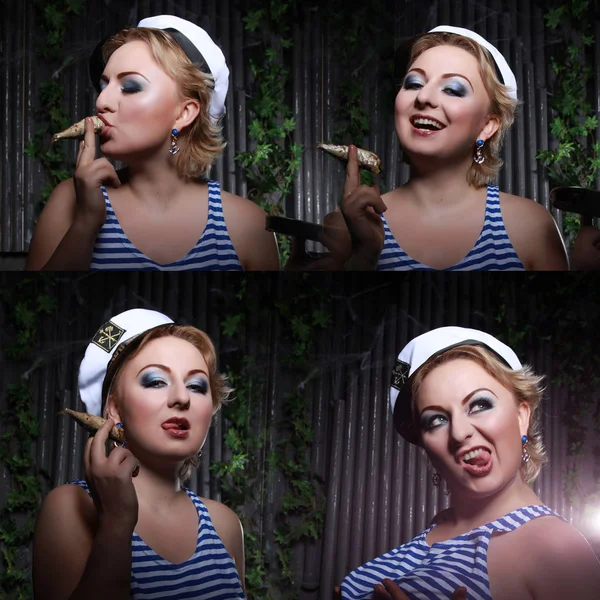 Sailor girl smoking small fish and having fun on black studio background alone — Stock Photo, Image