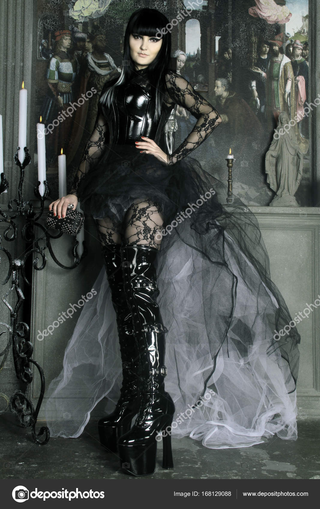 Beautiful gothic lady wearing lace catsuit and shiny black corset