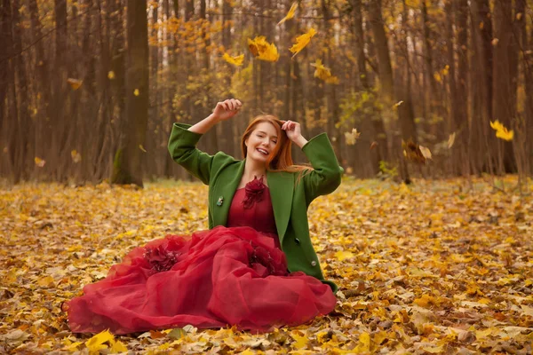 Hübsches Herbstmädchen mit roten Haaren allein im gelben Park — Stockfoto