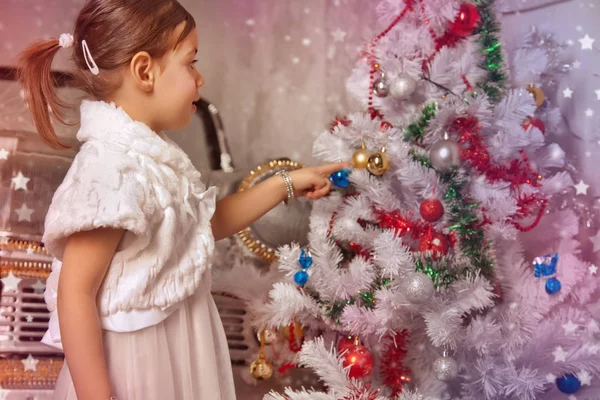 Pretty emotional little kid girl with christmas tree — Stock Photo, Image