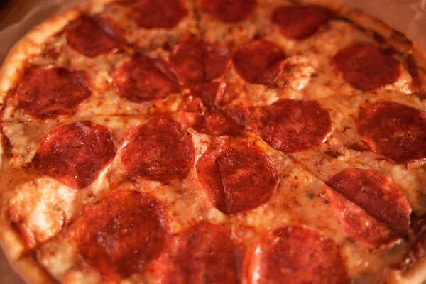 Finom, friss házi pizza az asztalon. klasszikus pepperoni pizza kolbásszal. — Stock Fotó