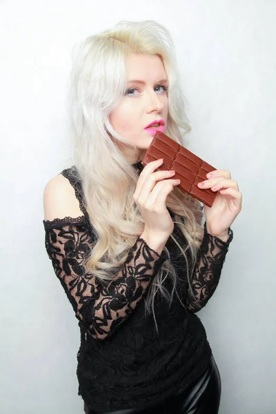 Mladá dívka stravovací balíček čokolády izolovaných na bílém pozadí — Stock fotografie