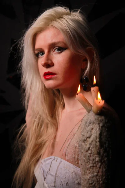 Mystical girl with candles that stand on wax on the girls skin — Stock Photo, Image